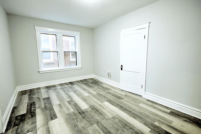 5027 S Broadway Ave Unit 1-4, Saint Louis, MO 63111 - empty room with wood finished floors and baseboards