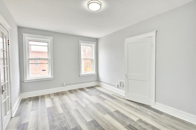 5027 S Broadway Ave Unit 1-4, Saint Louis, MO 63111 - empty room featuring wood finished floors, healthy amount of natural light, and baseboards