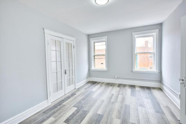 5027 S Broadway Ave Unit 1-4, Saint Louis, MO 63111 - unfurnished room featuring french doors, wood finished floors, baseboards, and healthy amount of natural light