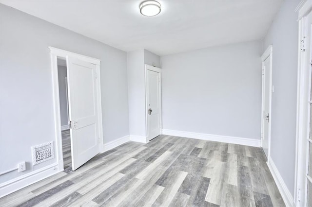 5027 S Broadway Ave Unit 1-4, Saint Louis, MO 63111 - unfurnished bedroom featuring wood finished floors and baseboards