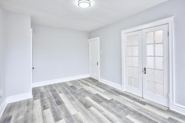 5027 S Broadway Ave Unit 1-4, Saint Louis, MO 63111 - spare room featuring wood finished floors, french doors, and baseboards