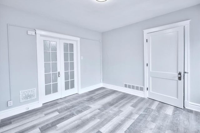 5027 S Broadway Ave Unit 1-4, Saint Louis, MO 63111 - unfurnished room featuring wood finished floors, baseboards, and french doors