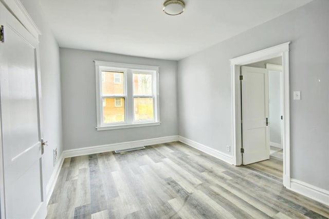 5027 S Broadway Ave Unit 1-4, Saint Louis, MO 63111 - spare room featuring light wood-style flooring and baseboards