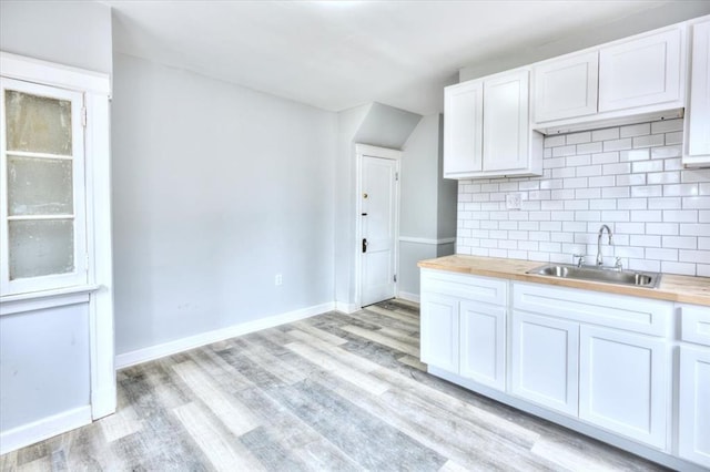 5027 S Broadway Ave Unit 1-4, Saint Louis, MO 63111 - kitchen with wooden counters, a sink, backsplash, and light wood-style floors