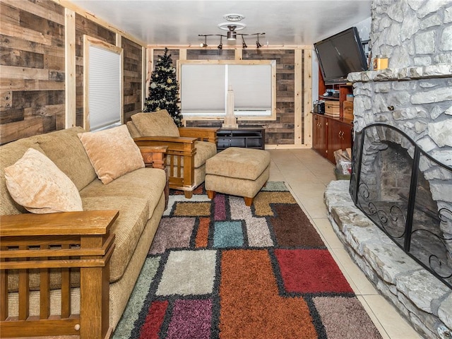 584 Watch Hill Rd, Collinsville, IL 62234 - living area featuring wooden walls, tile patterned flooring, and a stone fireplace