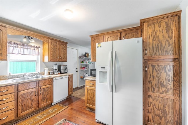 700 E S Main St, Dexter, MO 63841 - kitchen with white appliances, a sink, wood finished floors, light countertops, and brown cabinetry