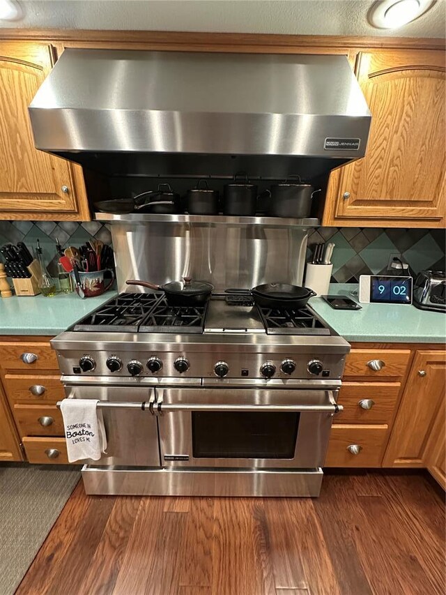 16 Siesta Dr, Hannibal, MO 63401 - kitchen featuring stainless steel range, backsplash, brown cabinets, and light countertops