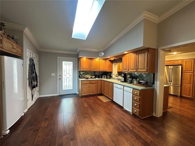 16 Siesta Dr, Hannibal, MO 63401 - kitchen featuring white appliances, dark wood finished floors, tasteful backsplash, a skylight, and light countertops