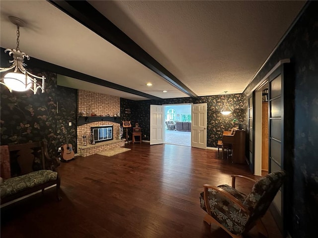 16 Siesta Dr, Hannibal, MO 63401 - living room with wallpapered walls, wood finished floors, a chandelier, beam ceiling, and a textured ceiling