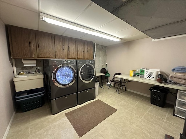 16 Siesta Dr, Hannibal, MO 63401 - laundry area with washing machine and dryer, light tile patterned floors, baseboards, and cabinet space