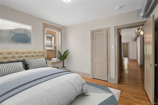 4932 Mardel, Saint Louis, MO 63109 - bedroom with light wood-style flooring, multiple windows, and baseboards