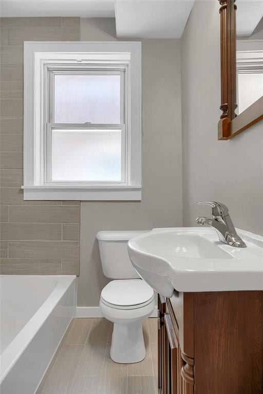 4932 Mardel, Saint Louis, MO 63109 - bathroom featuring a bath, vanity, toilet, and baseboards