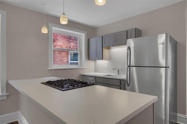 4932 Mardel, Saint Louis, MO 63109 - kitchen featuring freestanding refrigerator, gray cabinetry, a sink, tasteful backsplash, and pendant lighting