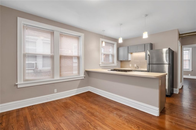 4932 Mardel, Saint Louis, MO 63109 - kitchen featuring stainless steel appliances, dark wood-style flooring, baseboards, light countertops, and backsplash