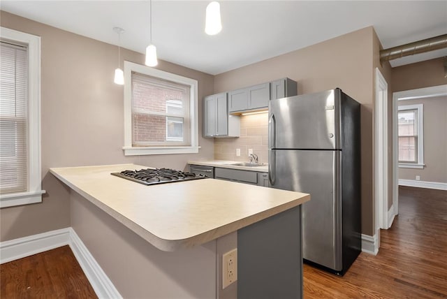 4932 Mardel, Saint Louis, MO 63109 - kitchen featuring stainless steel appliances, baseboards, gray cabinetry, dark wood finished floors, and a sink