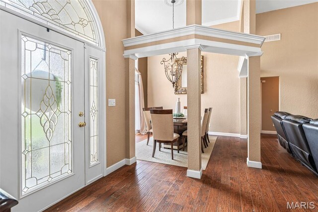 113 Riverwalk Dr, Desloge, MO 63628 - foyer entrance with a chandelier, dark wood finished floors, baseboards, and decorative columns