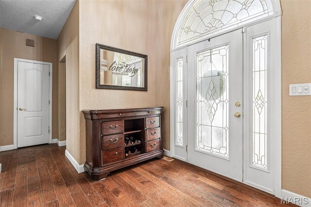 113 Riverwalk Dr, Desloge, MO 63628 - foyer with dark wood-style floors, a textured wall, and baseboards