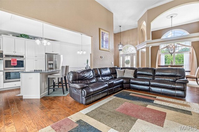113 Riverwalk Dr, Desloge, MO 63628 - living room with a chandelier, dark wood finished floors, ornamental molding, and a textured wall