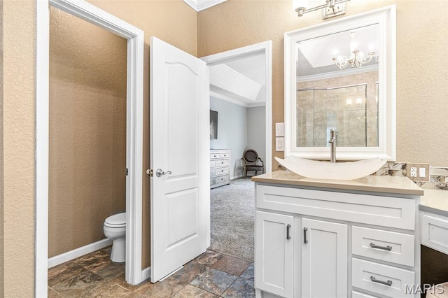 113 Riverwalk Dr, Desloge, MO 63628 - bathroom featuring ornamental molding, vanity, toilet, stone finish flooring, and a textured wall