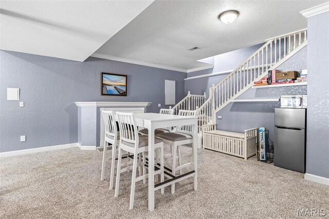113 Riverwalk Dr, Desloge, MO 63628 - dining space featuring a textured wall, crown molding, baseboards, carpet floors, and a textured ceiling