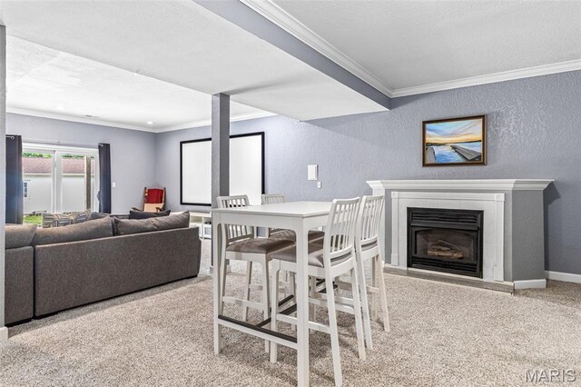 113 Riverwalk Dr, Desloge, MO 63628 - carpeted dining room featuring a textured wall, crown molding, a fireplace with raised hearth, and baseboards