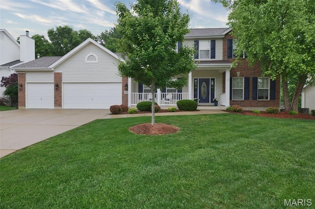 2654 Breckenridge Cir, Ofallon, MO 63368 - view of front facade featuring brick siding, driveway, an attached garage, covered porch, and a front yard