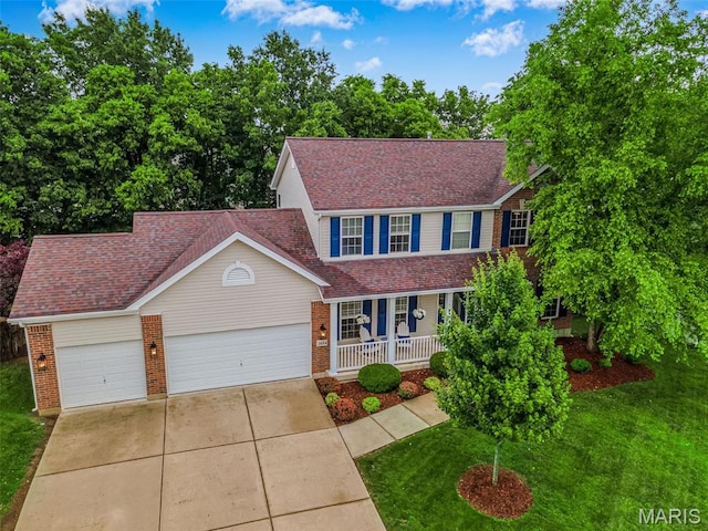2654 Breckenridge Cir, Ofallon, MO 63368 - view of front facade featuring covered porch, brick siding, concrete driveway, and a garage