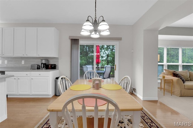 2654 Breckenridge Cir, Ofallon, MO 63368 - dining room featuring light wood-type flooring, a chandelier, and baseboards