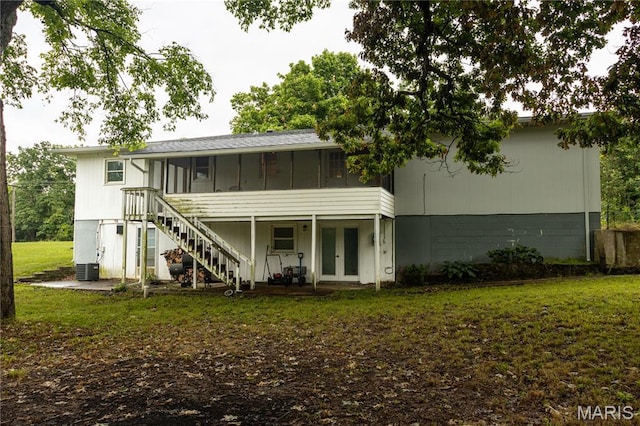 24506 State Road A, Richland, MO 65556 - rear view of property with french doors, a sunroom, a yard, stairs, and central AC