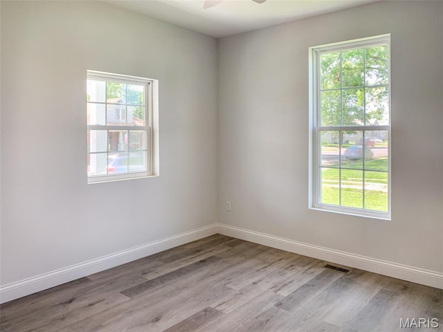 526 State St, Dupo, IL 62239 - unfurnished room with wood finished floors, plenty of natural light, ceiling fan, and baseboards
