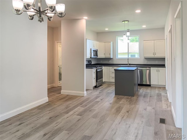 526 State St, Dupo, IL 62239 - kitchen featuring appliances with stainless steel finishes, a chandelier, dark countertops, a sink, and recessed lighting