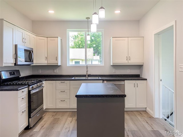 526 State St, Dupo, IL 62239 - kitchen with appliances with stainless steel finishes, a sink, light wood-style flooring, dark countertops, and recessed lighting