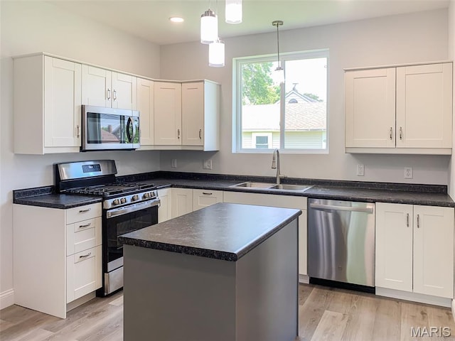 526 State St, Dupo, IL 62239 - kitchen with appliances with stainless steel finishes, a sink, light wood-style floors, recessed lighting, and white cabinetry