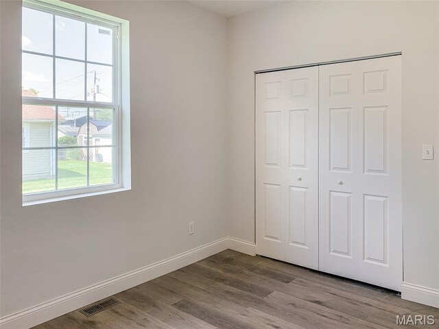 526 State St, Dupo, IL 62239 - unfurnished bedroom with wood finished floors, baseboards, and a closet