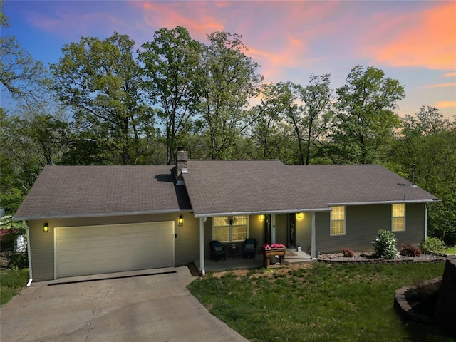 7172 Briarwood Dr, Cedar Hill, MO 63016 - ranch-style home featuring a garage, concrete driveway, a chimney, a front lawn, and view of wooded area