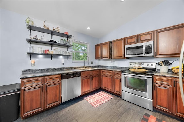 7172 Briarwood Dr, Cedar Hill, MO 63016 - kitchen featuring stainless steel appliances, a sink, dark countertops, lofted ceiling, and dark wood finished floors