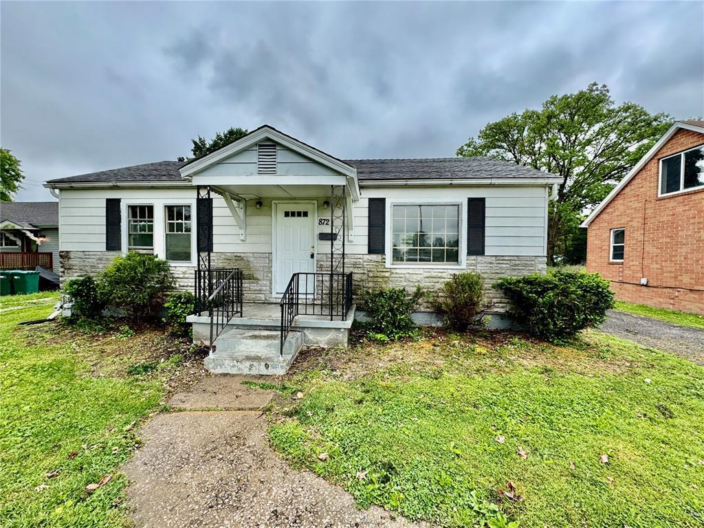 872 Jerome Ln, Cahokia, IL 62206 - bungalow with stone siding, a front lawn, and roof with shingles