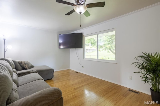 13012 Hencher Rd, De Soto, MO 63020 - living room with ornamental molding, light wood finished floors, baseboards, and a ceiling fan