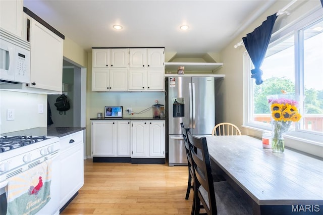 13012 Hencher Rd, De Soto, MO 63020 - kitchen featuring white appliances, white cabinetry, light wood-style floors, open shelves, and dark countertops