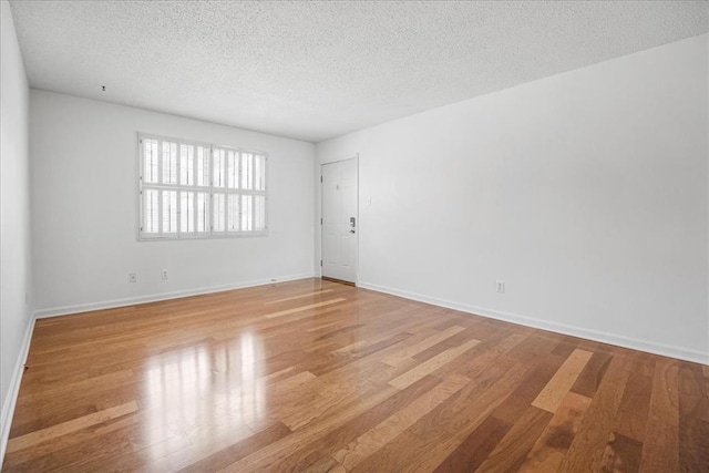1721 Blue Jay Cv, Saint Louis, MO 63144 - empty room featuring a textured ceiling, wood finished floors, and baseboards