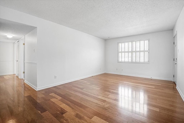 1721 Blue Jay Cv, Saint Louis, MO 63144 - empty room with a textured ceiling, wood finished floors, and baseboards