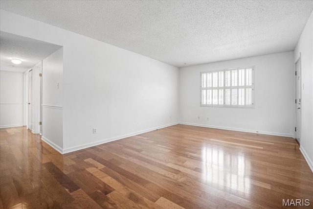 1721 Blue Jay Cv, Saint Louis, MO 63144 - unfurnished room featuring a textured ceiling and wood finished floors