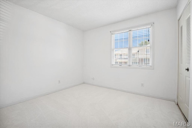 1721 Blue Jay Cv, Saint Louis, MO 63144 - unfurnished bedroom featuring carpet, a closet, and a textured ceiling