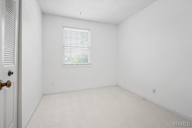 1721 Blue Jay Cv, Saint Louis, MO 63144 - unfurnished room with carpet flooring and a textured ceiling