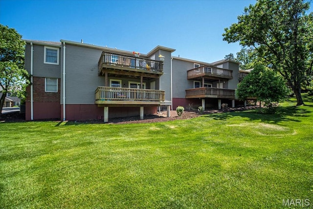 1721 Blue Jay Cv, Saint Louis, MO 63144 - back of house featuring a lawn, a wooden deck, and a balcony