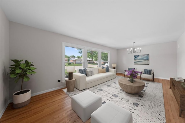 1865 Shardell Dr, Spanish Lake Township, MO 63138 - living room featuring light wood finished floors, a chandelier, and baseboards