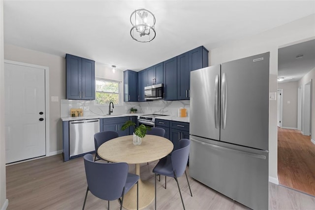 1865 Shardell Dr, Spanish Lake Township, MO 63138 - kitchen featuring stainless steel appliances, a sink, light wood-type flooring, and light countertops