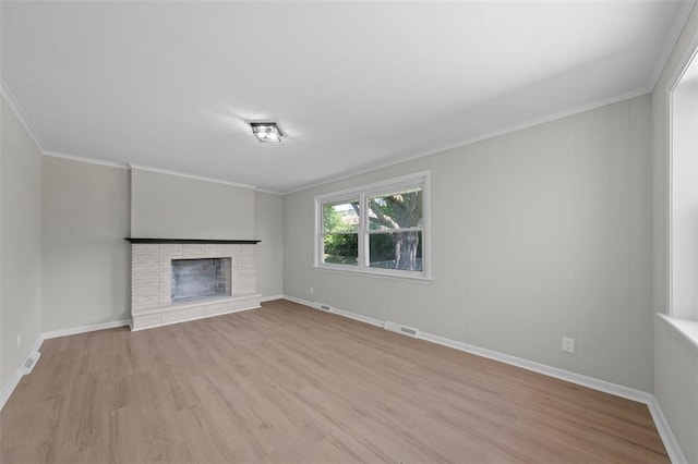 1865 Shardell Dr, Spanish Lake Township, MO 63138 - unfurnished living room with wood finished floors, a fireplace, ornamental molding, and baseboards