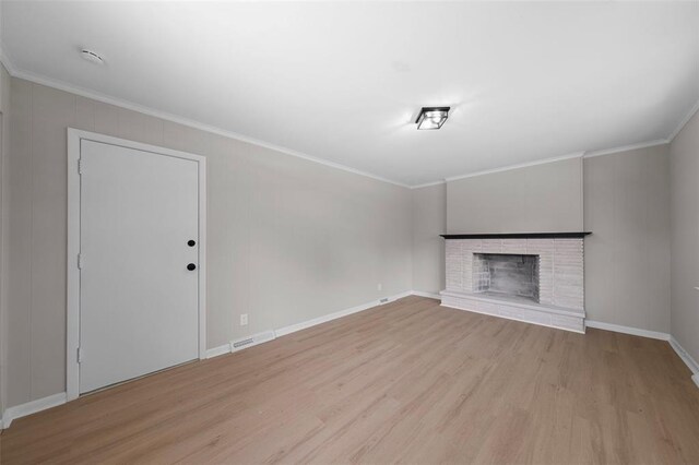 1865 Shardell Dr, Spanish Lake Township, MO 63138 - unfurnished living room featuring ornamental molding, wood finished floors, a brick fireplace, and baseboards