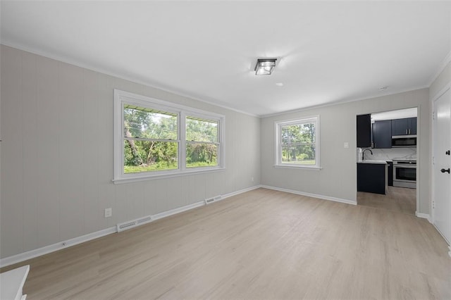 1865 Shardell Dr, Spanish Lake Township, MO 63138 - unfurnished room featuring light wood-type flooring, crown molding, a sink, and baseboards
